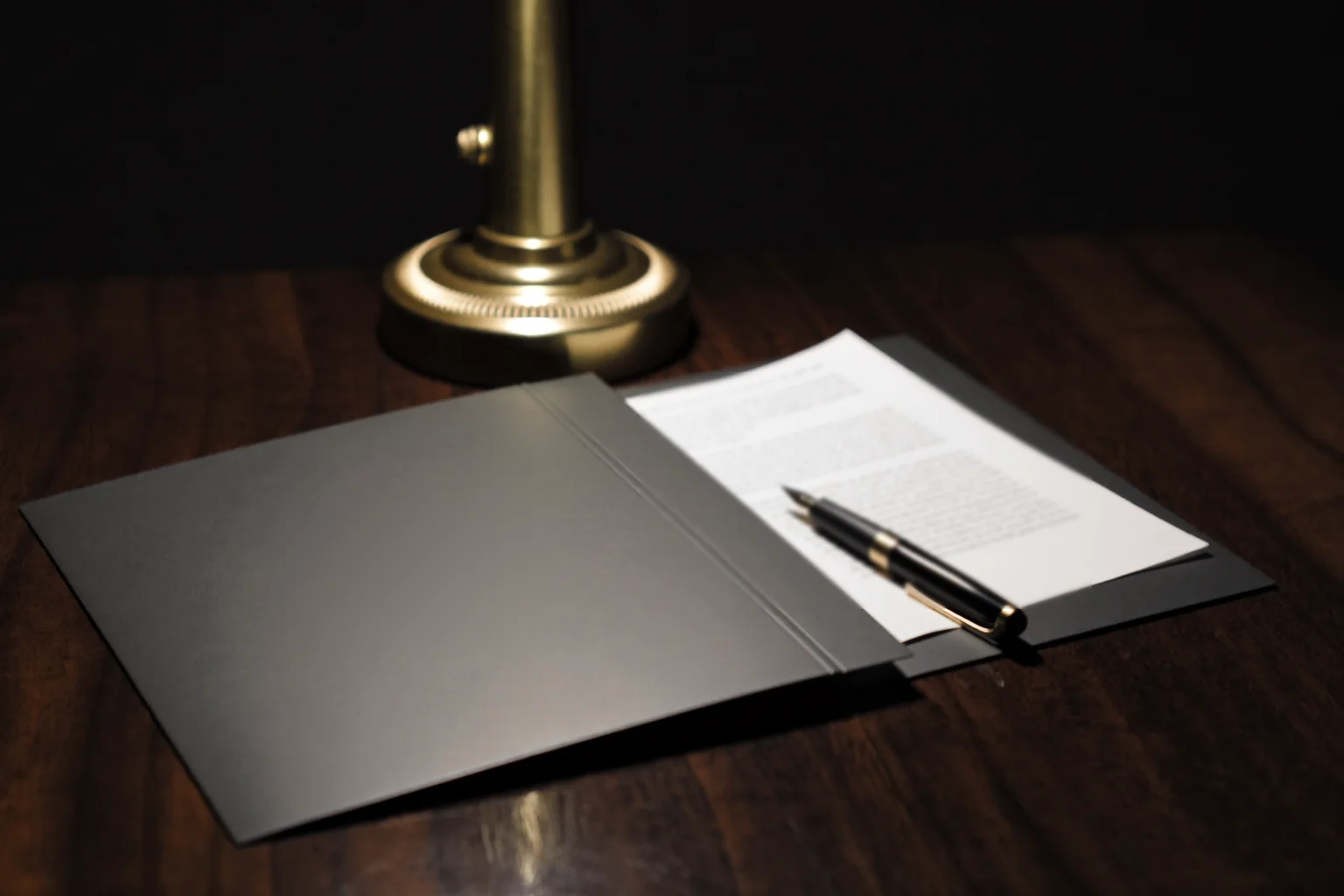 Car insurance policy papers on a desk under warm lamplight