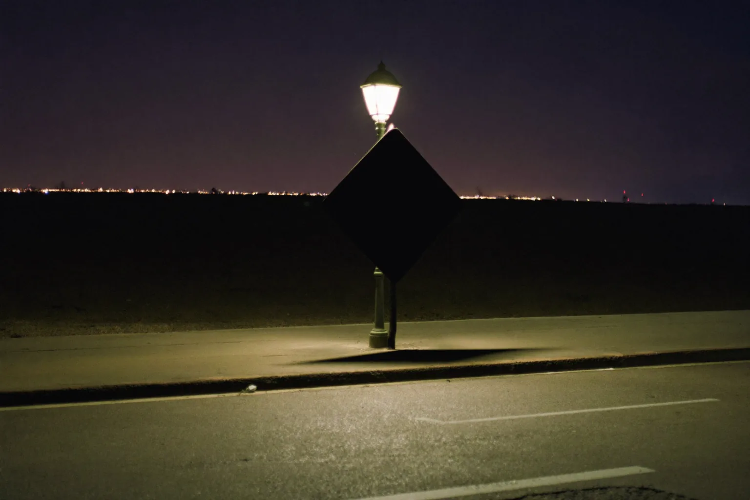 Roadside warning sign and lantern ahead of a police stop on a Nevada road